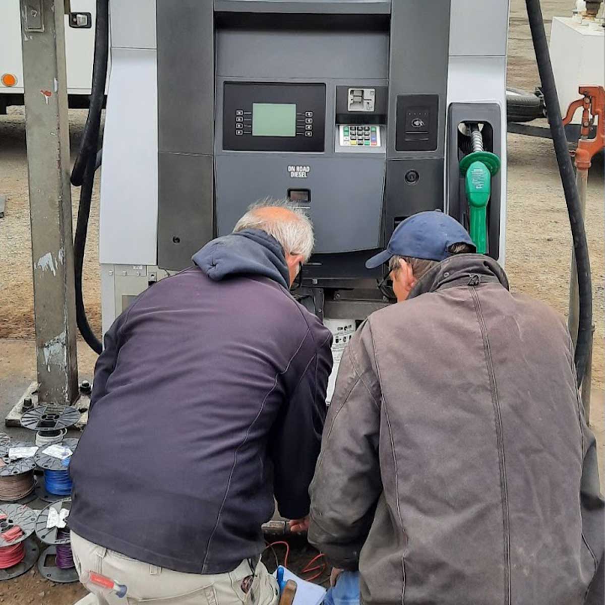 Two men servicing a gas pump - Coeur d'Alene Service Station Equipment