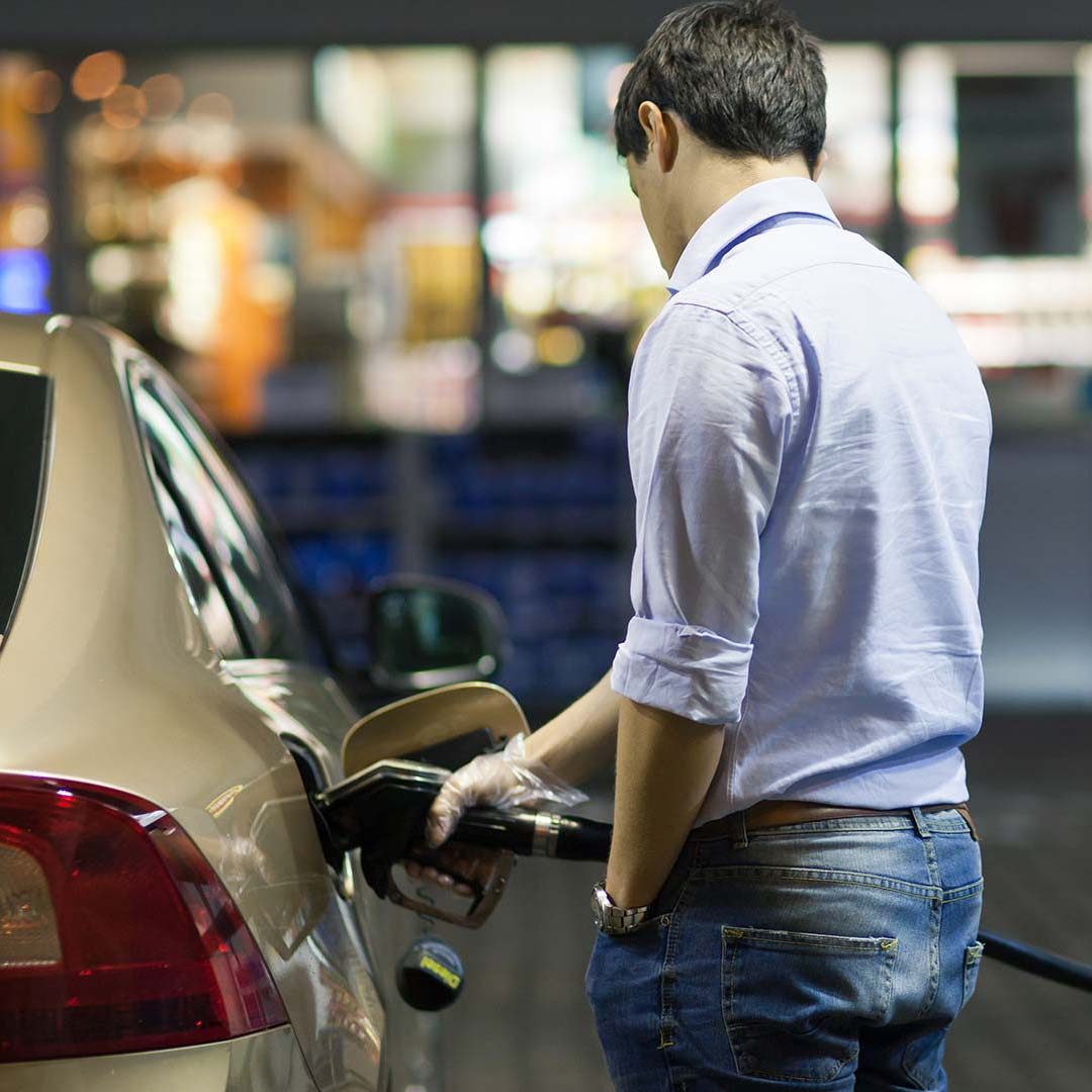 Man pumping fuel into a car
